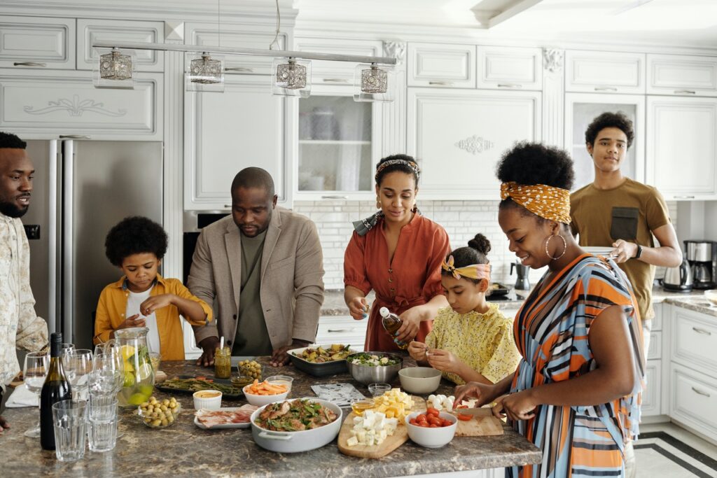 family making food in a kitchen representing the peace of mind you can have after getting teen therapy or therapy for teens and parents in Cincinnati, oh 