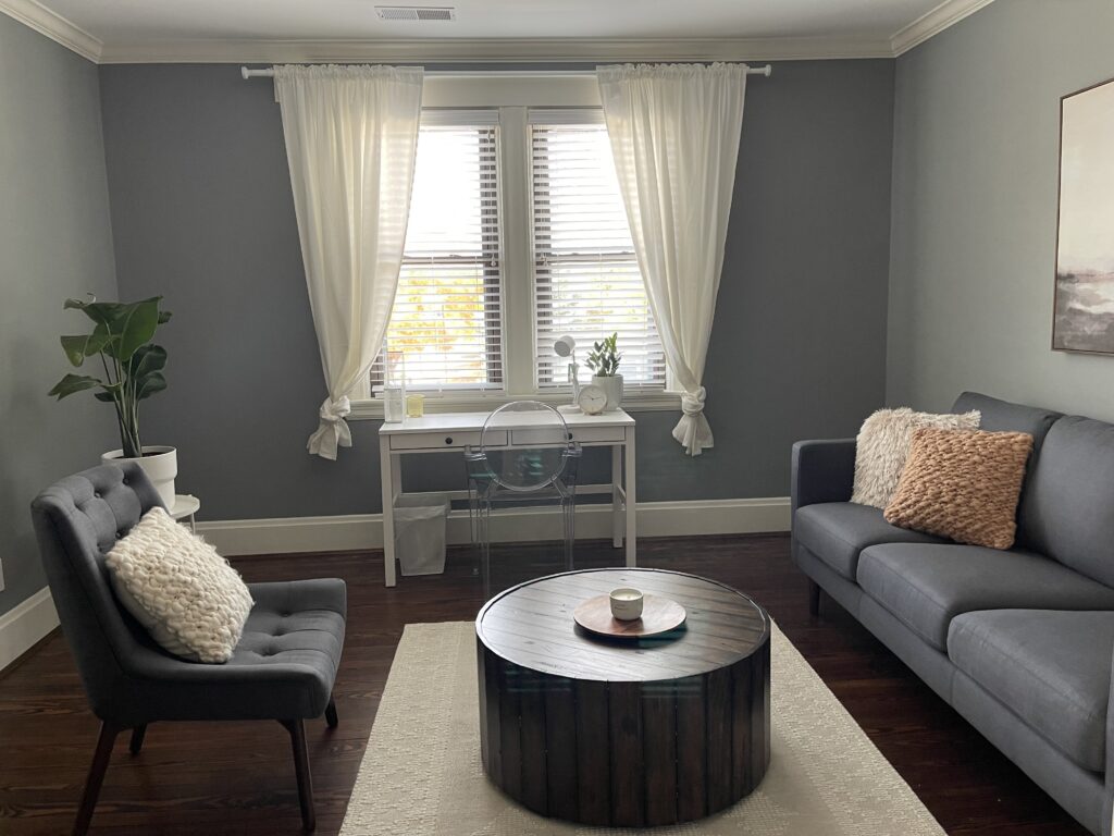 The therapy office of Emma Schmidt with a couch and therapist chair. Learn how marriage counseling in Ft. Mitchell, KY or depression treatment can help you today. 45208