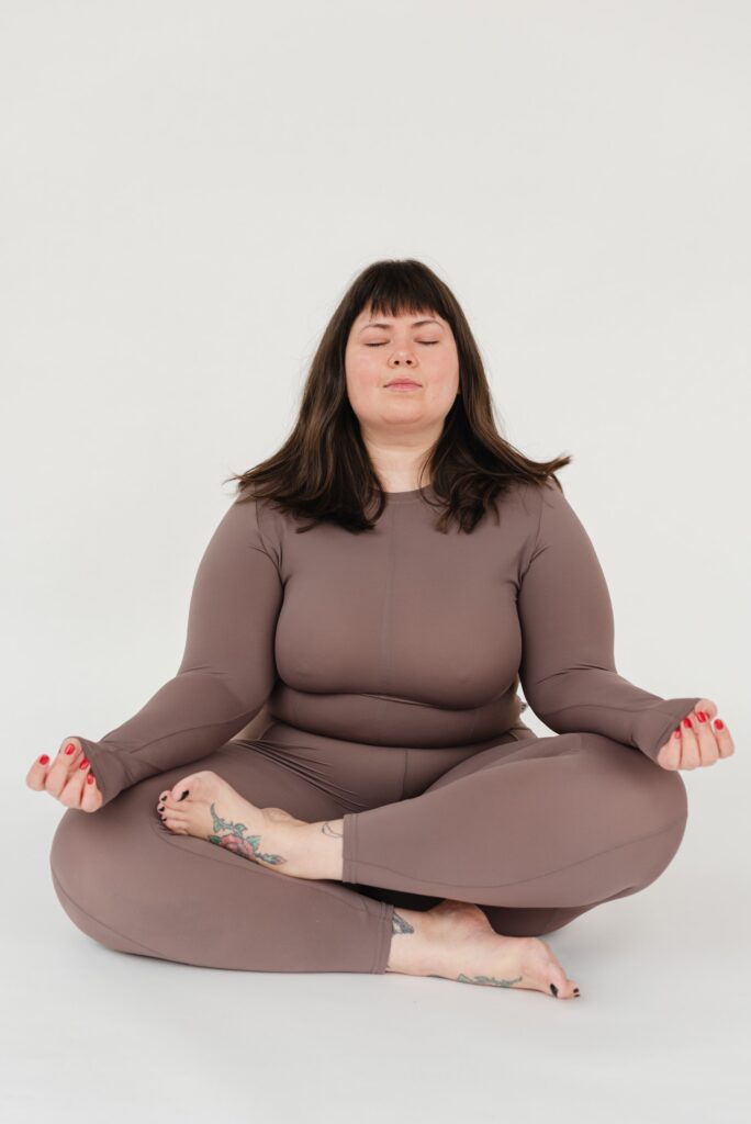 A woman sits cross-legged in a yoga pose. This could represent yoga therapy in Cincinnati, OH. Learn more about online yoga therapy in Kentucky, yoga for sexual wellness in Cincinnati, OH, and other services. 45208 