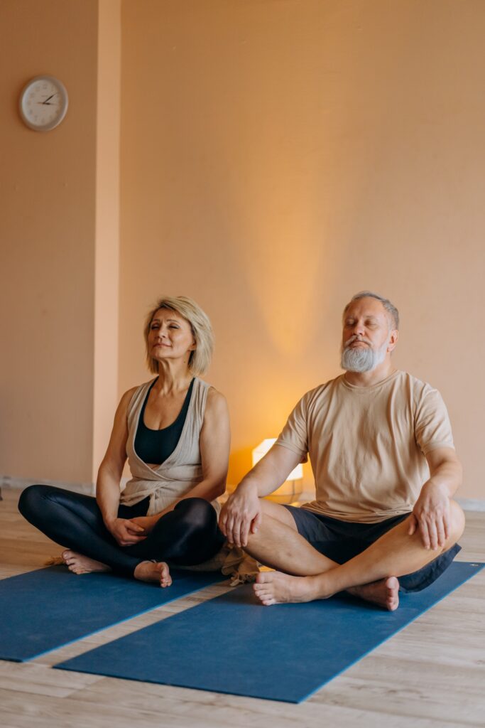 A middle aged couple sit on yoga mats next to one another. This could represent the bond yoga therapy in Ft. Mitchell, KY can cultivate. Contact a yoga therapist in Cincinnati, OH to learn more about online yoga therapy in Kentucky and other services. 45208
