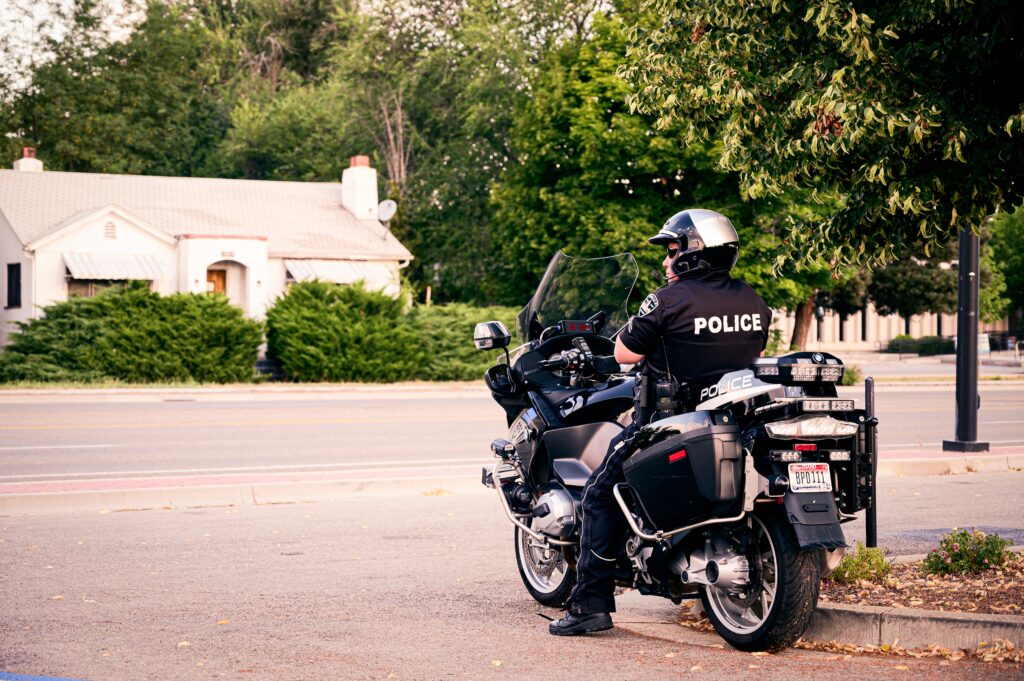 A cop sits on their motorcycle while watching the road. Relationship counseling in Indiana can help improve relationships of first responders. Contact an online therapist in Ohio to learn more about our intimacy workshop in Cincinnati, OH and other services.