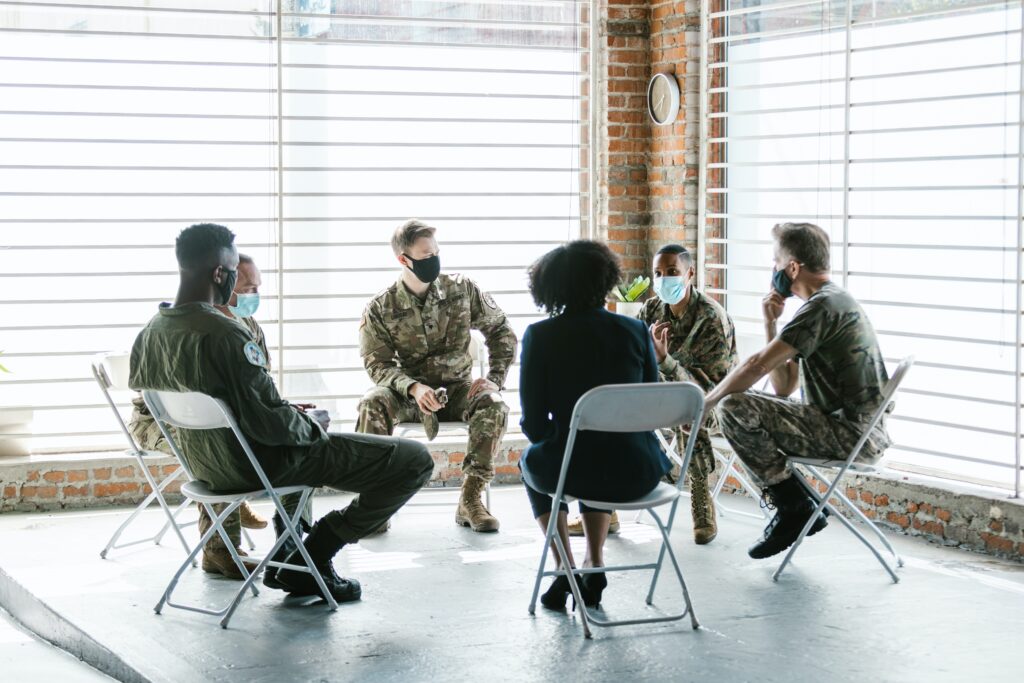 A group of people wearing masks sit in a circle of chairs. PTSD treatment in Cincinnati, OH can help you with both individual and group therapy. Learn more about trauma treatment in Cincinnati, OH by contacting a trauma therapist in Cincinnati, OH today.